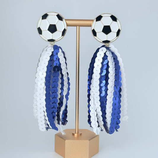 Decorative wall piece with soccer ball designs and sequined patterns on a light gray background