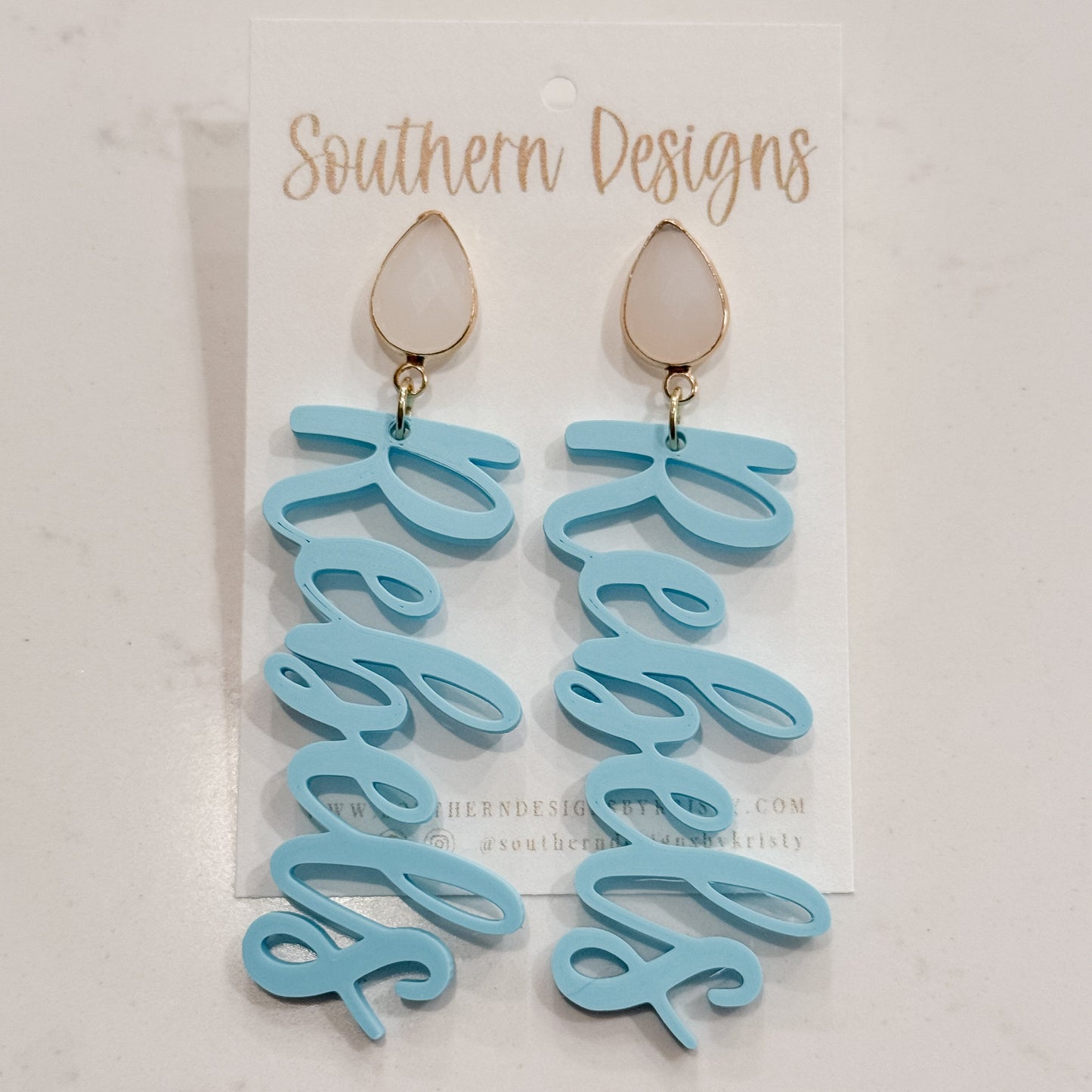 Light blue script earrings on a clear card with 'Southern Designs' branding.