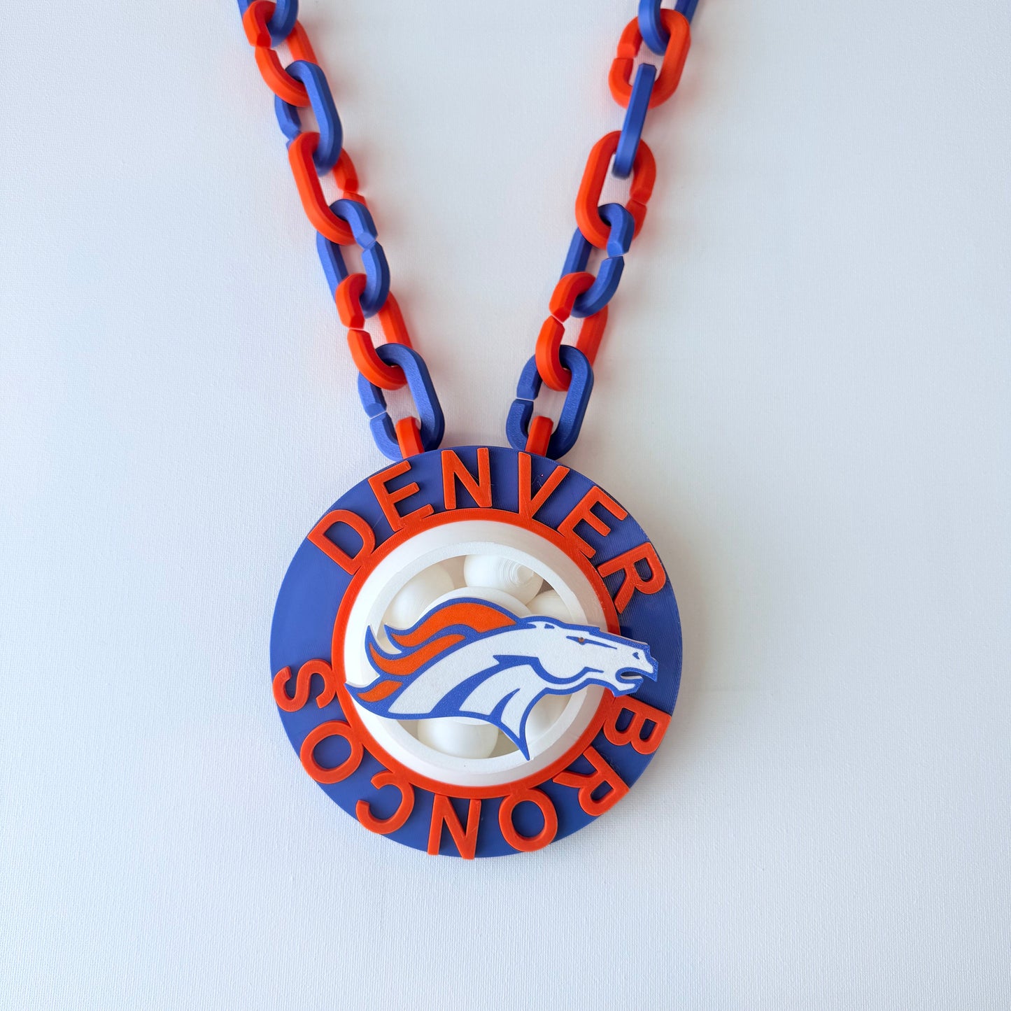 Denver Broncos logo and chain on a white background