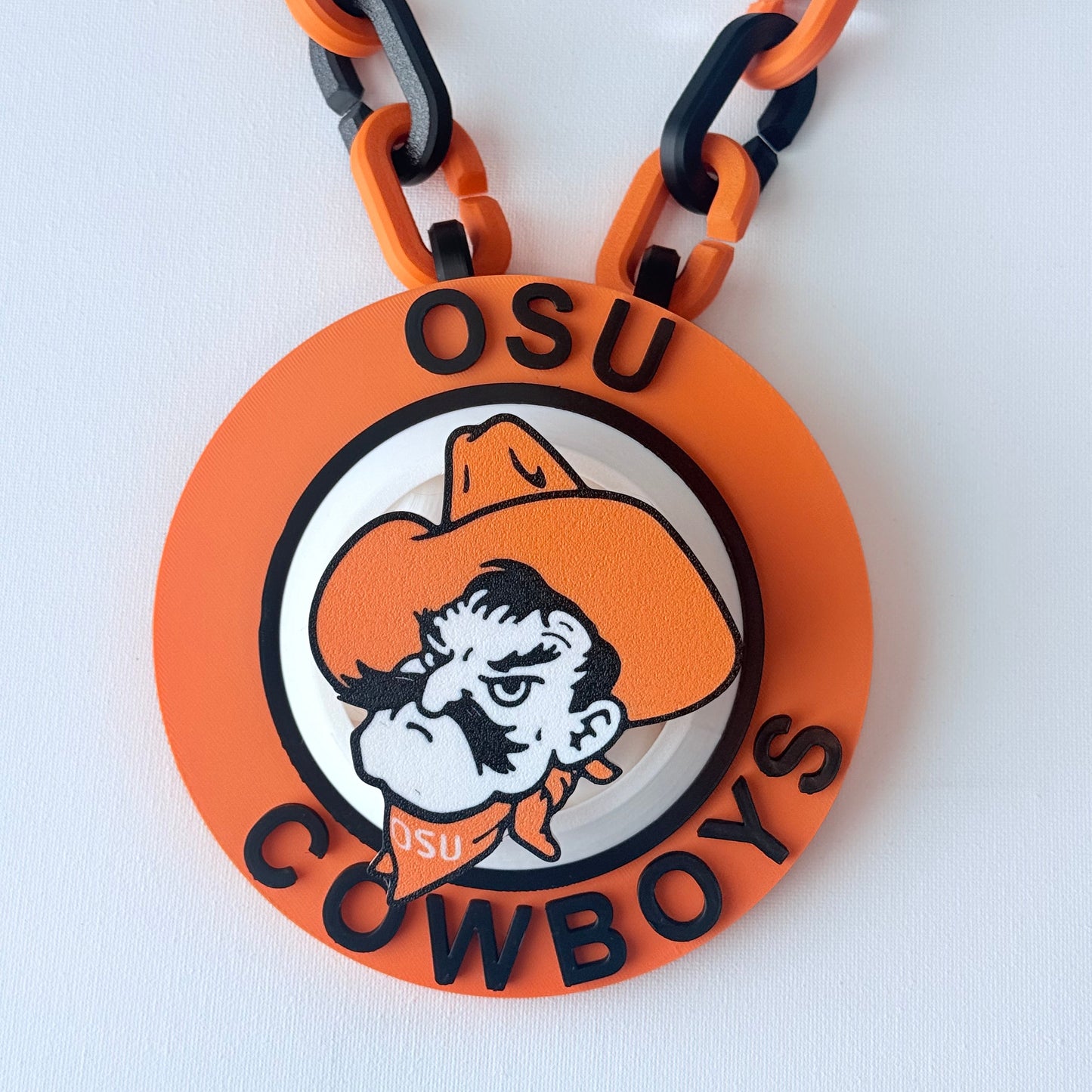 Orange and black chain with a 'Cowboys' logo on a white background