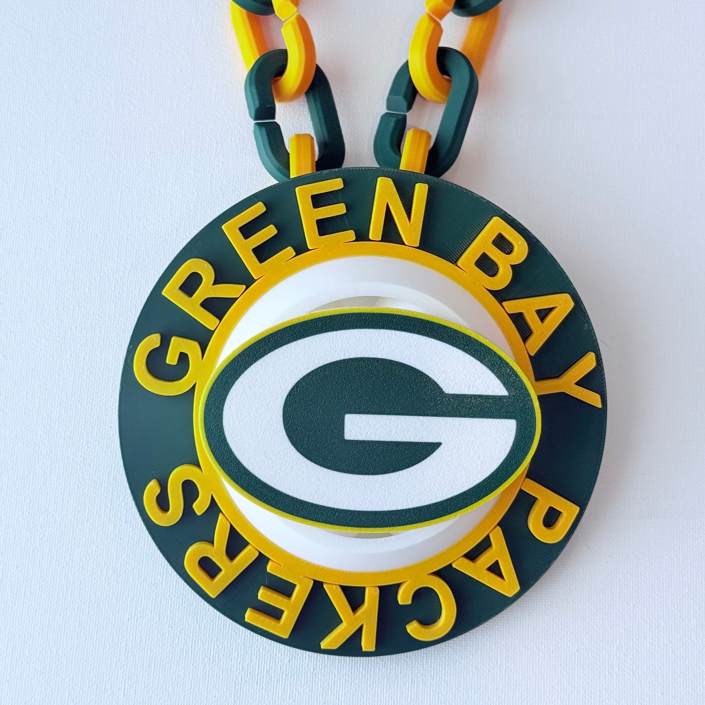 Green Bay Packers logo on a chain with a white background